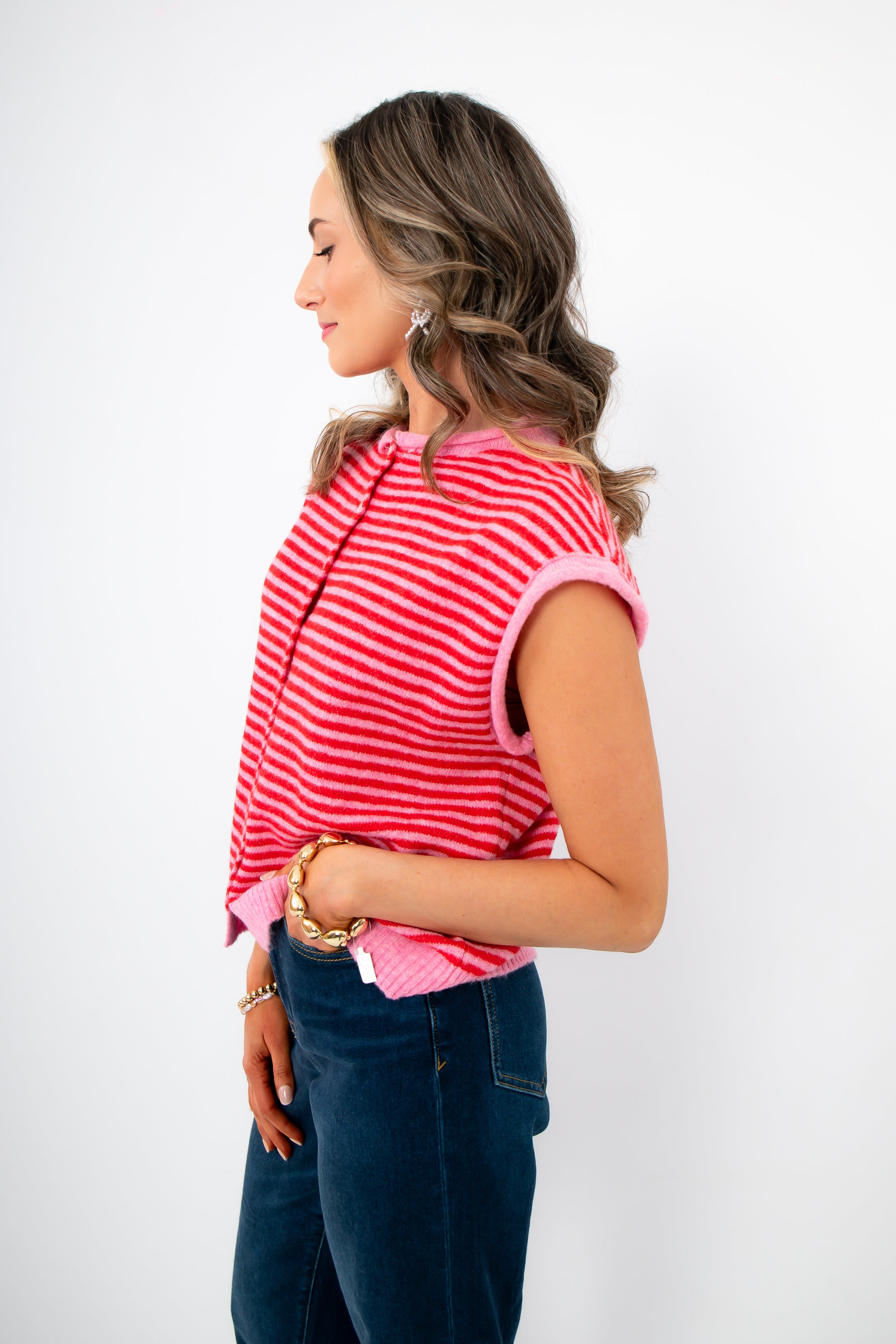 Side view of Piper Pink Stripe Short Sleeve Cardigan highlighting relaxed fit, cap sleeves, and soft knit texture for warm weather wear.