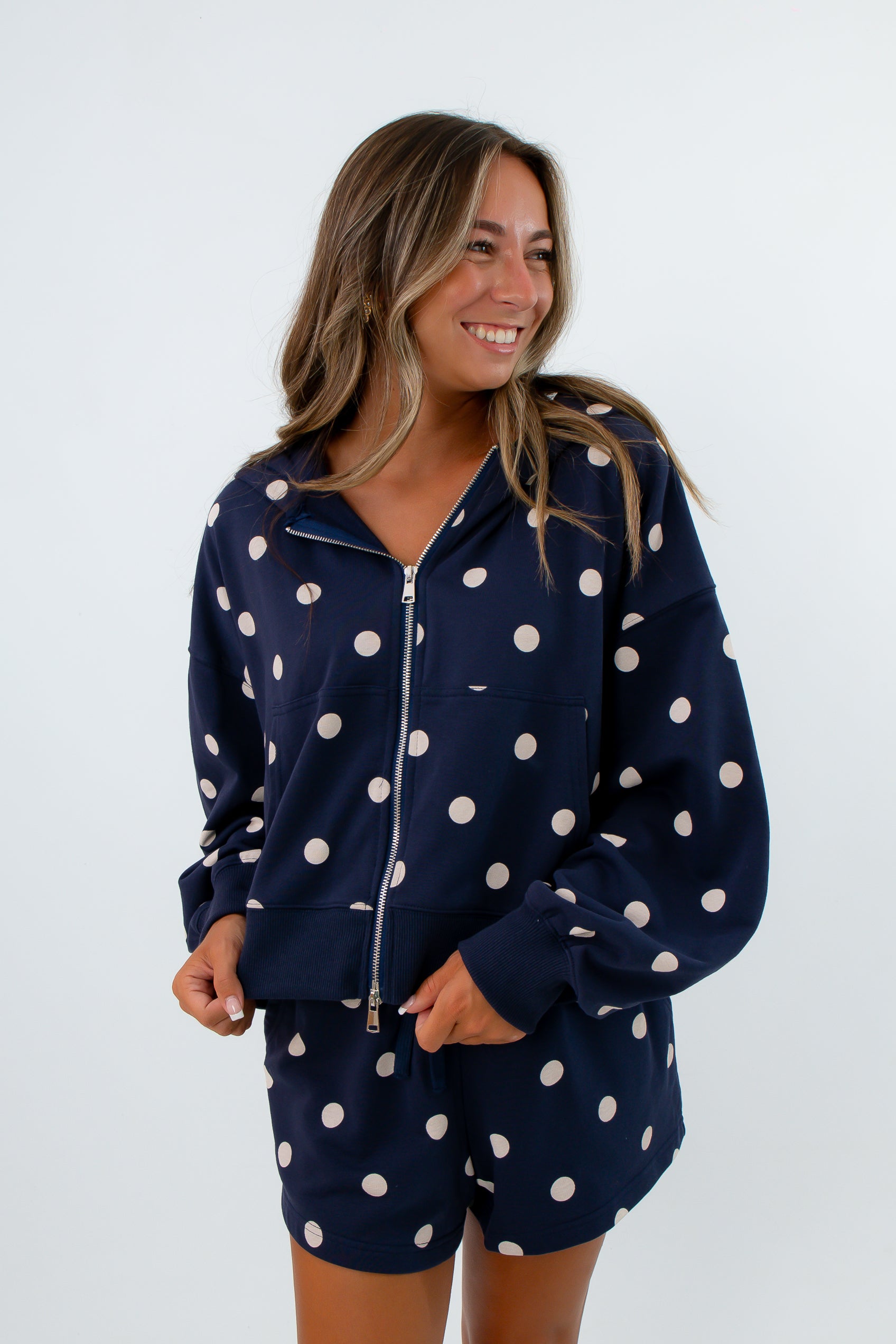 Comfortable navy hooded sweatshirt with zip and pockets paired with matching navy polka dot shorts