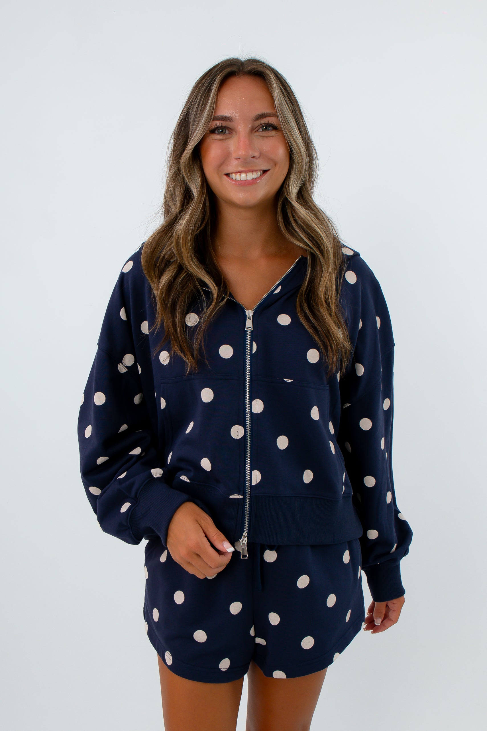 Navy and white polka dot jacket with dual zipper and side pockets, polka dot shorts set, navy and white matching lounge set