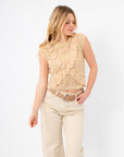 Boho-inspired sleeveless crochet top with front lace ruffles, styled effortlessly with high-waisted beige denim.