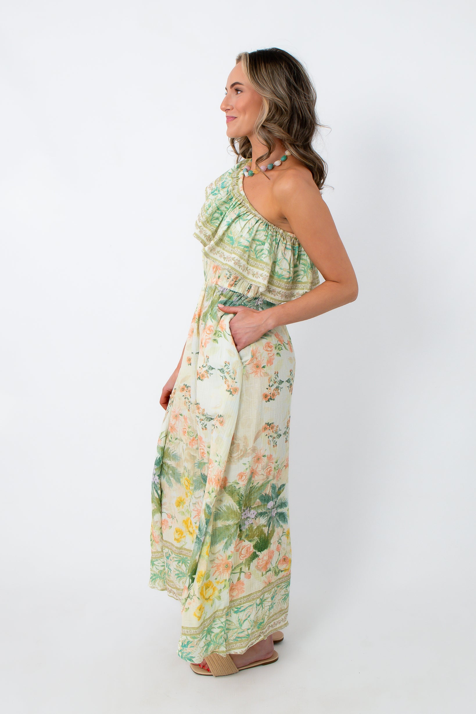 Side view of tropical garden midi dress with floral pattern and pockets