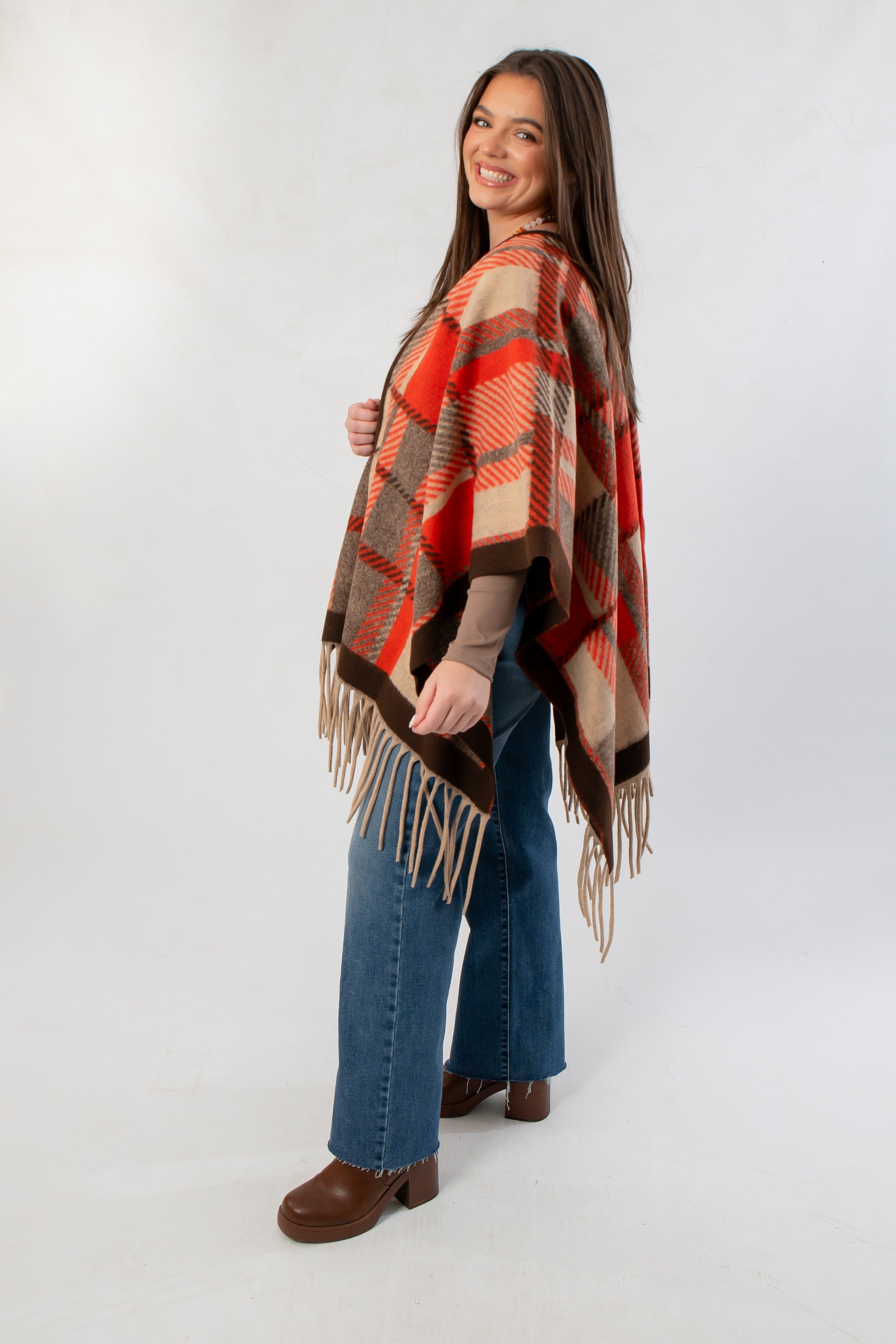 Side view of Fireside Plaid Shawl featuring warm orange and beige tones, ideal for stylish fall layering with casual outfits.
