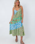 Colorful tiered midi dress with floral and leaf prints, adjustable straps, lightweight gauze fabric, summer beachwear