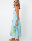 Side view of Allium Field Floral Embroidered Midi Dress featuring blue and green floral print, with a fitted bodice and flowing skirt