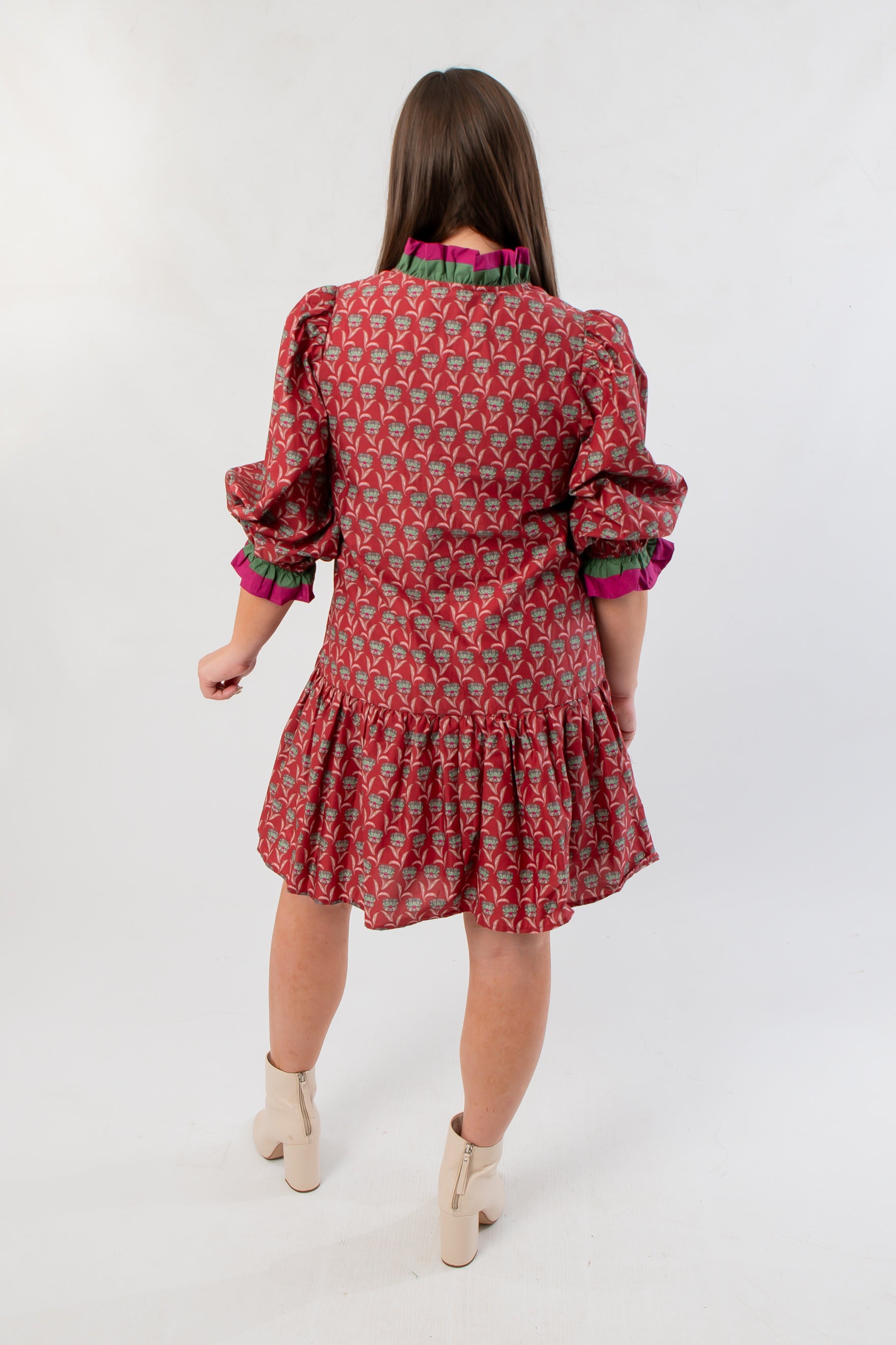 Back view of Mulberry Mistletoe Block Print Dress highlighting the festive block print and gathered skirt detail for a cheerful holiday look.