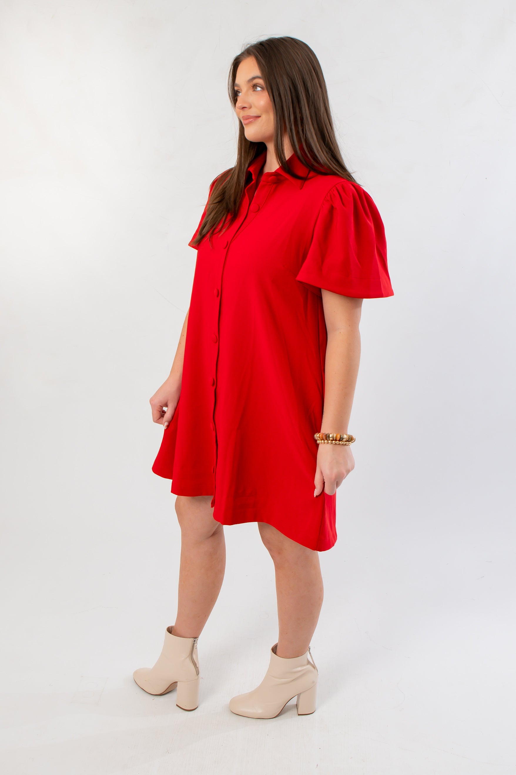 Side view of Eloise Red Crepe Button Mini Dress showcasing flutter sleeves and relaxed fit, ideal for Christmas and party season wear.