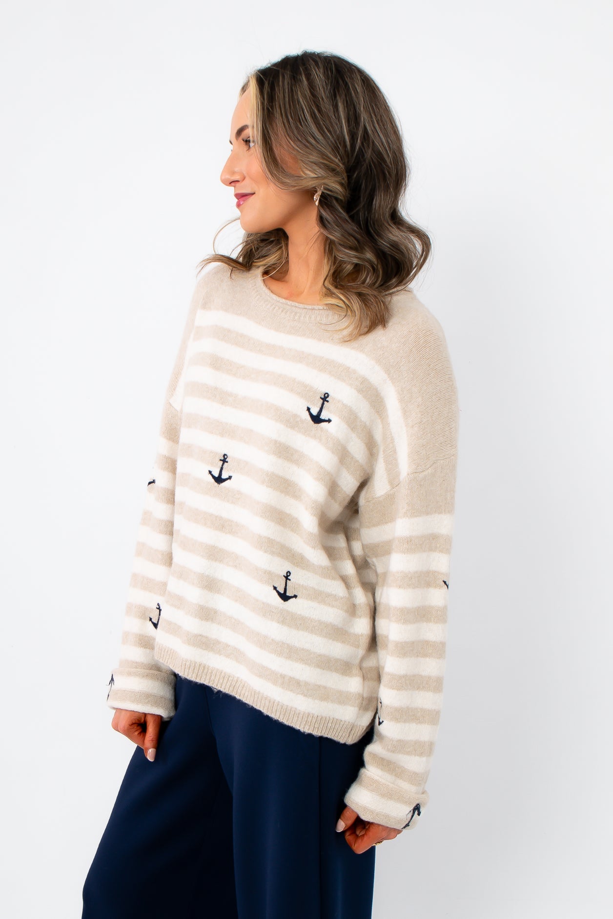 Side view of Anchors Away Taupe Stripe Sweater with anchor embroidery and beige-white horizontal stripes, styled for a laid-back nautical look.