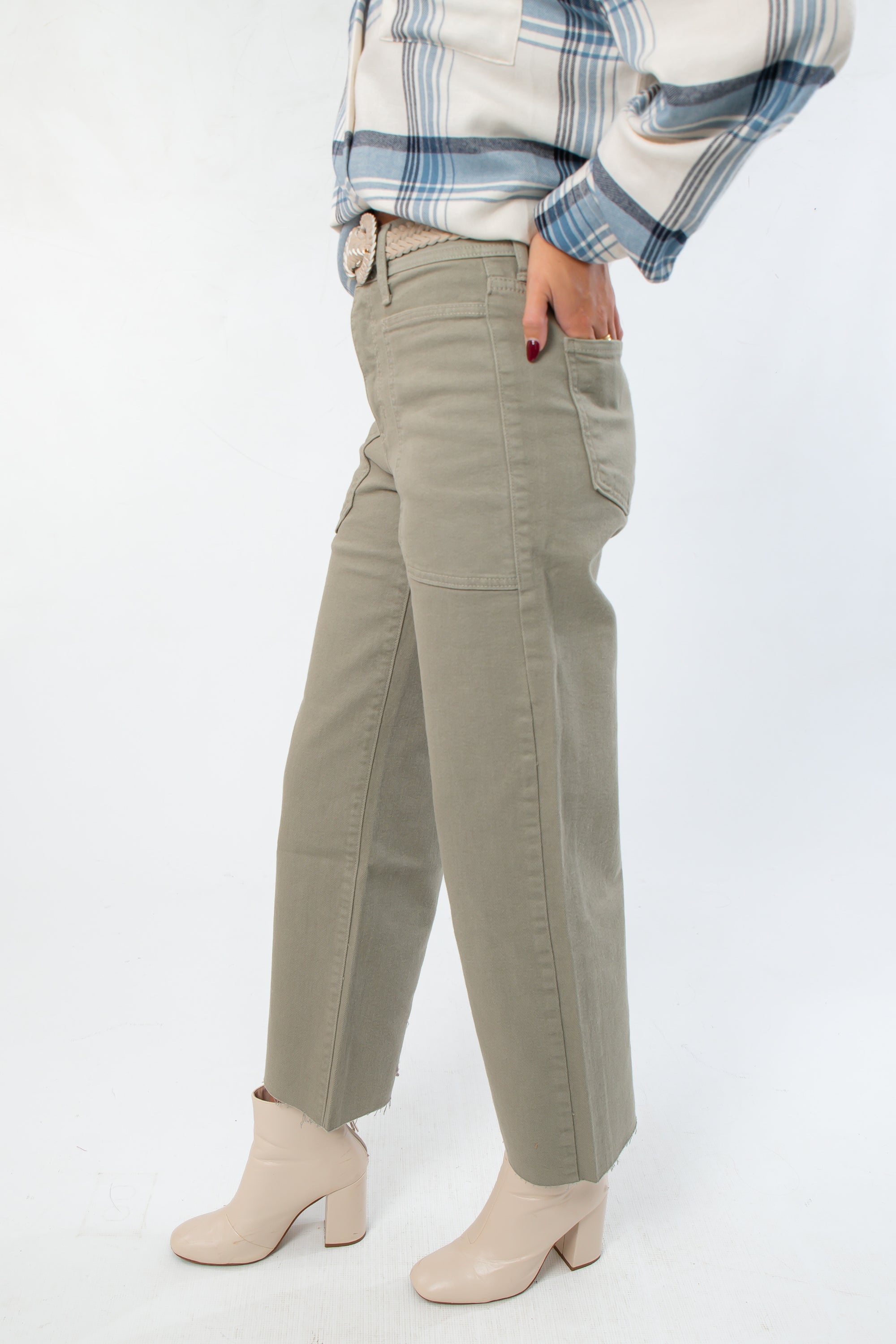 Side view of Rosemary Utility Wide Leg Jeans showing wide leg cut, cargo pocket detail, and raw hem in faded green denim.