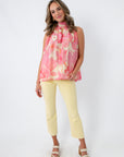 Pastel yellow ankle flare jeans with a flattering fit, styled with a pink floral top and platform sandals