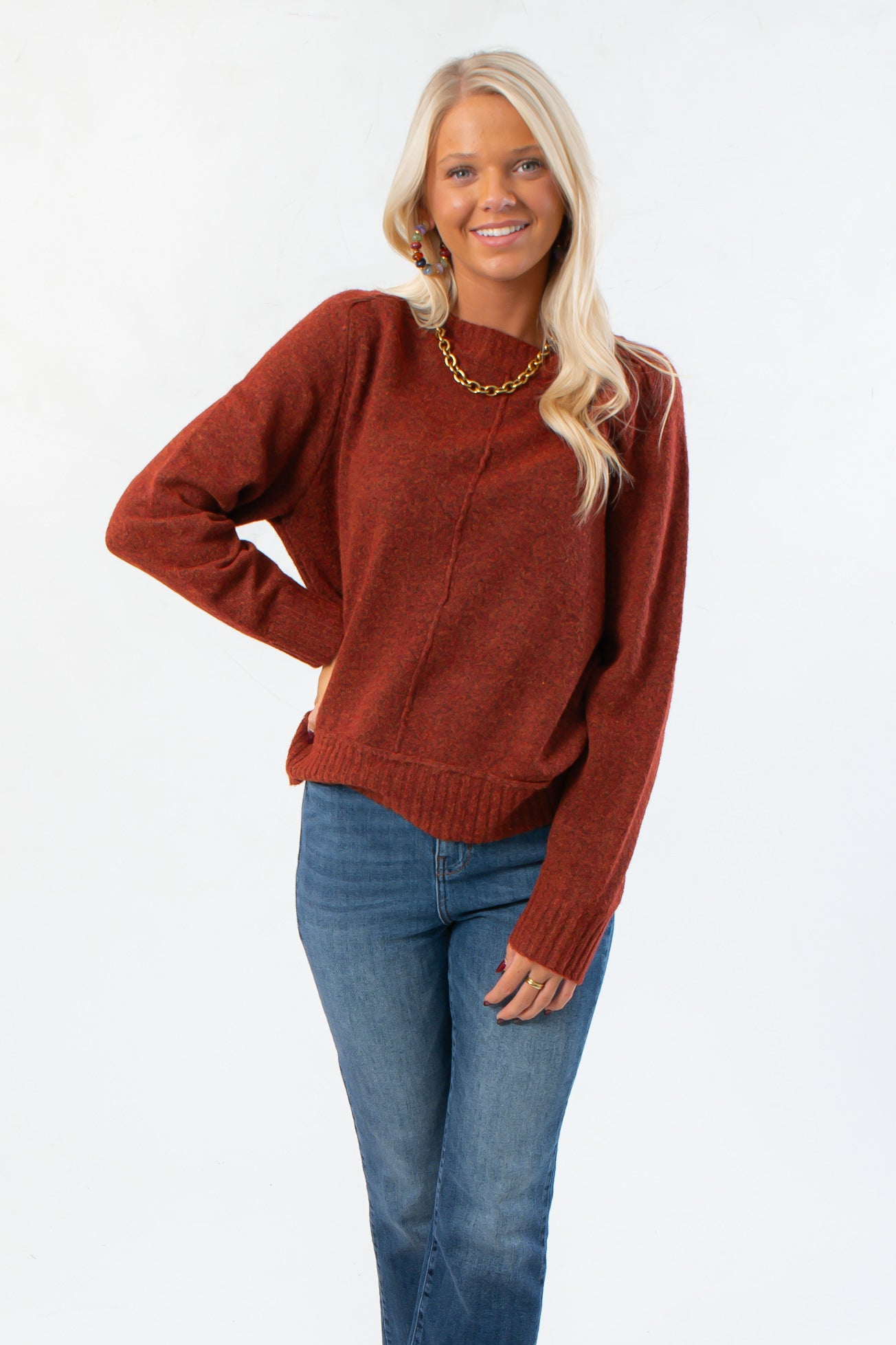 Take It Easy Rust Pullover Sweater with crew neckline and ribbed hem, styled for fall in cozy knit fabric. Ideal for layering with jeans.