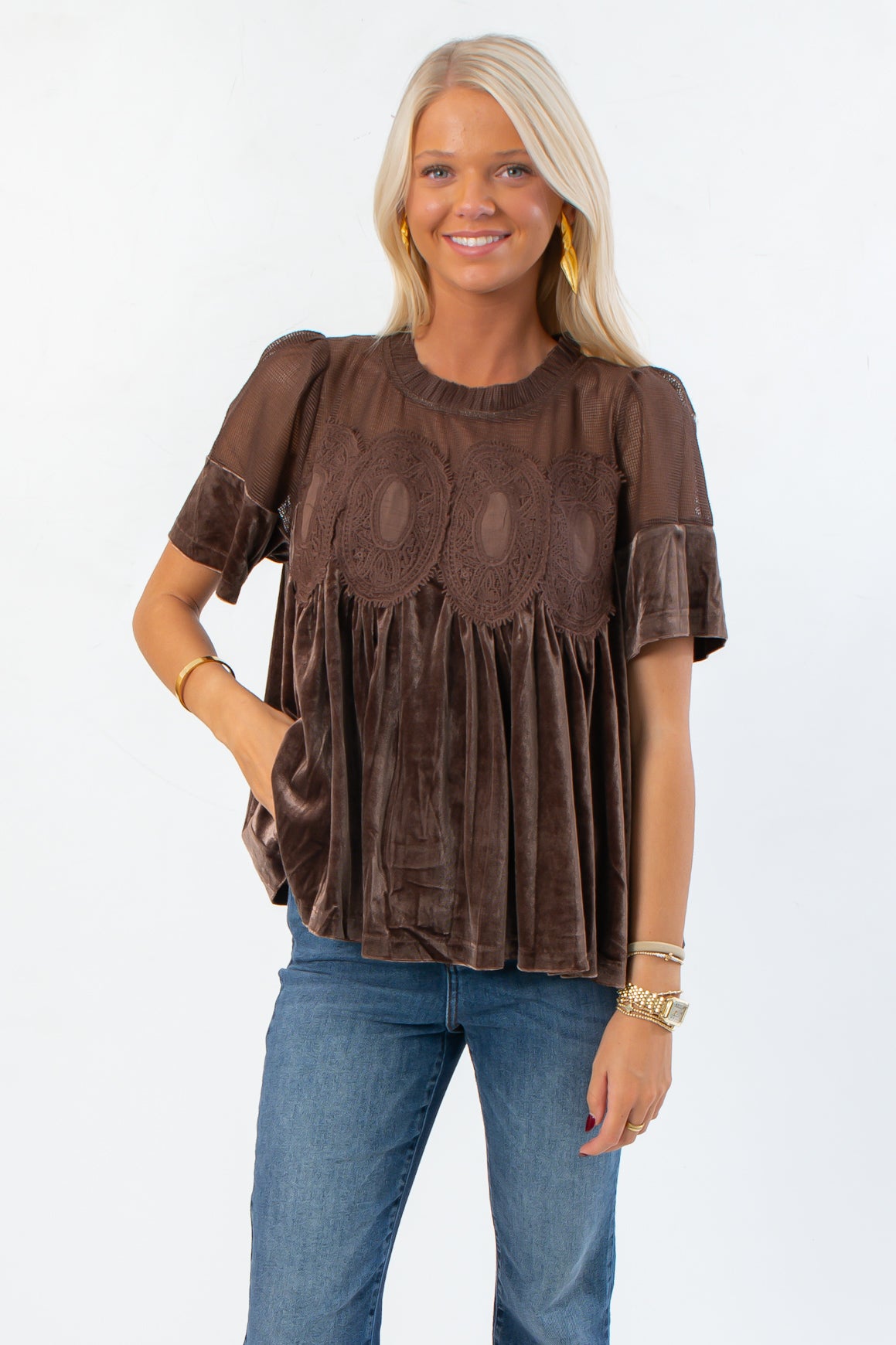 Lacy Brown Velvet Babydoll Top with lace yoke and short sleeves, styled with jeans for a chic fall look. Elegant mixed media blouse for layering.