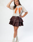 Sporty and stylish Bone Bow Crop Tshirt paired with a maroon tiered skirt, ideal for fans seeking a fashionable game day outfit.