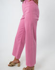 Pink high-rise wide leg denim jeans with model wearing floral top