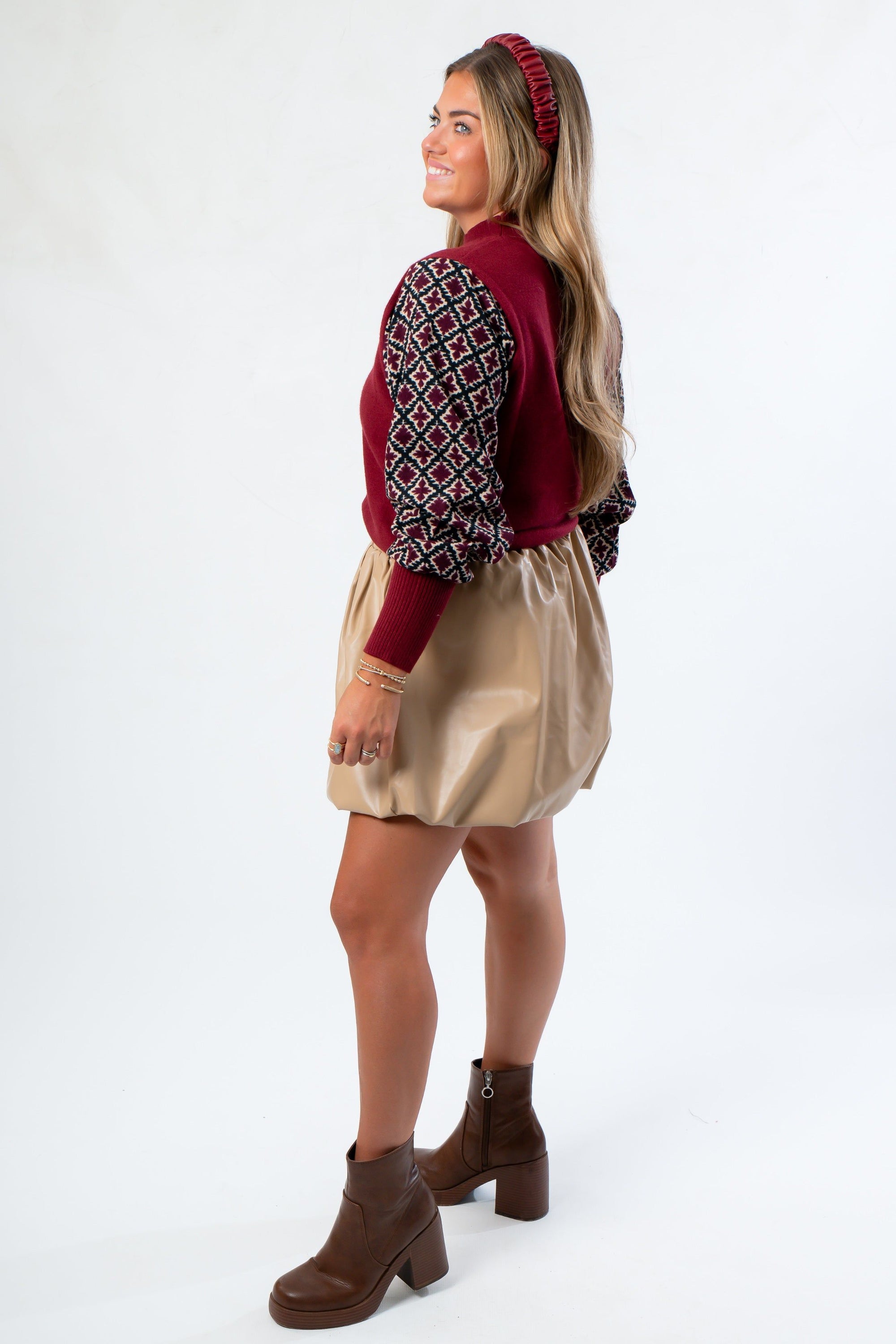 Side view of THML Mixed Media Garnet Knit Shirt with balloon sleeves and relaxed fit. Perfect for layering in fall fashion collections.