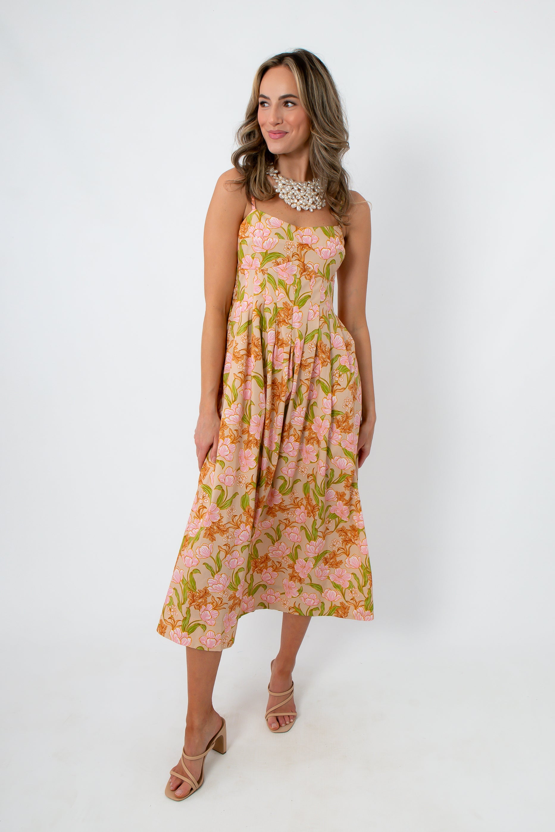 Side view of floral midi dress with pink and orange tulip print, featuring adjustable straps and a relaxed fit
