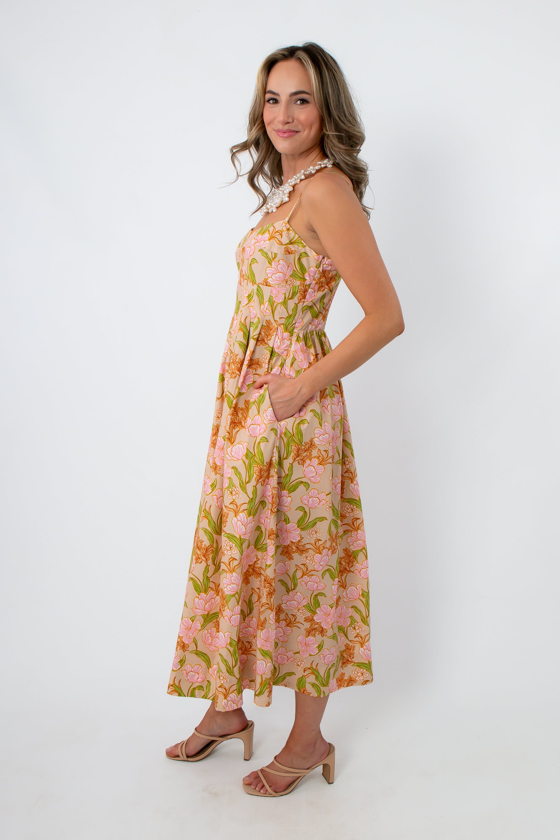 Back view of pink and orange tulip floral midi dress with adjustable straps and a gathered waist for spring events