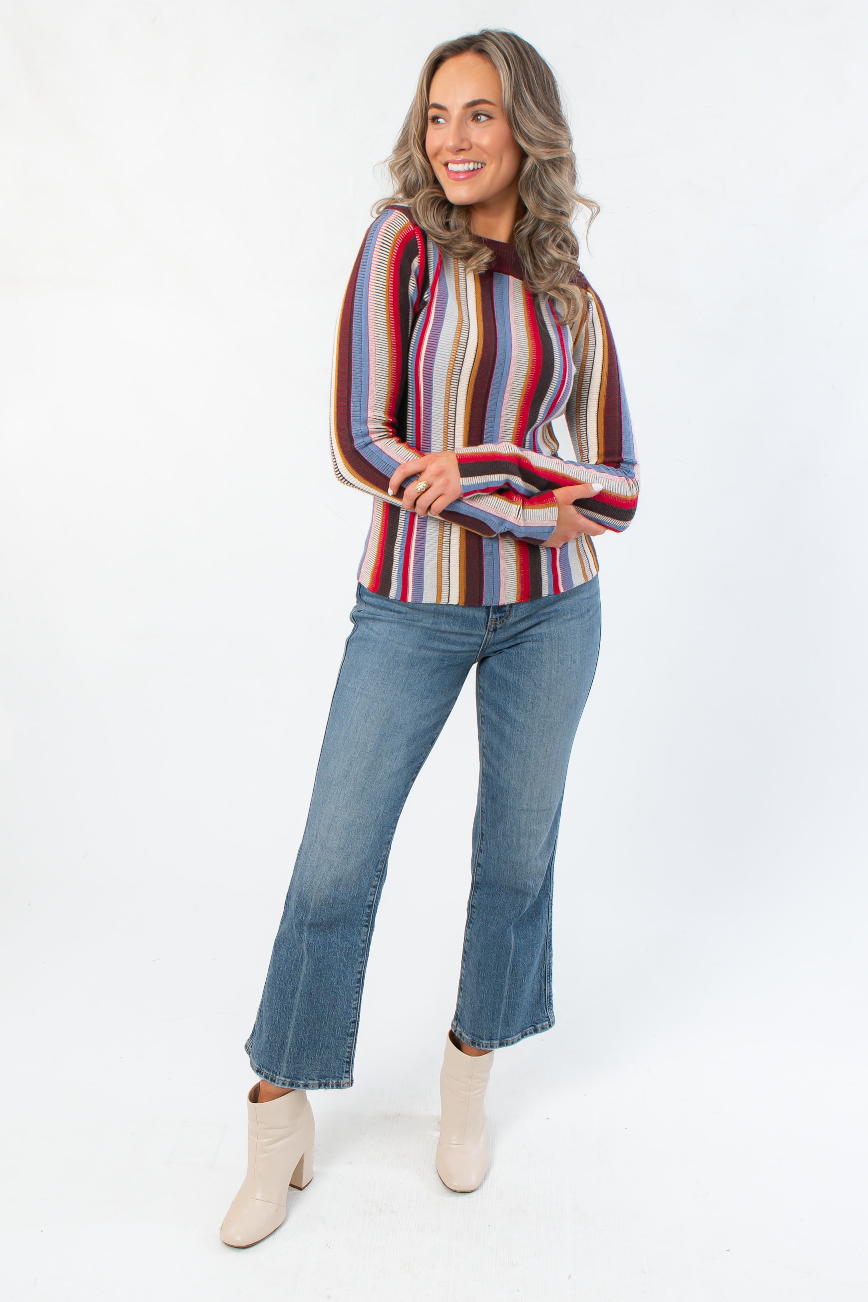 Supersoft Steve Madden Burgundy Serra Stripe Sweater featuring long sleeves and mixed stitching, paired with flared jeans and ankle boots.