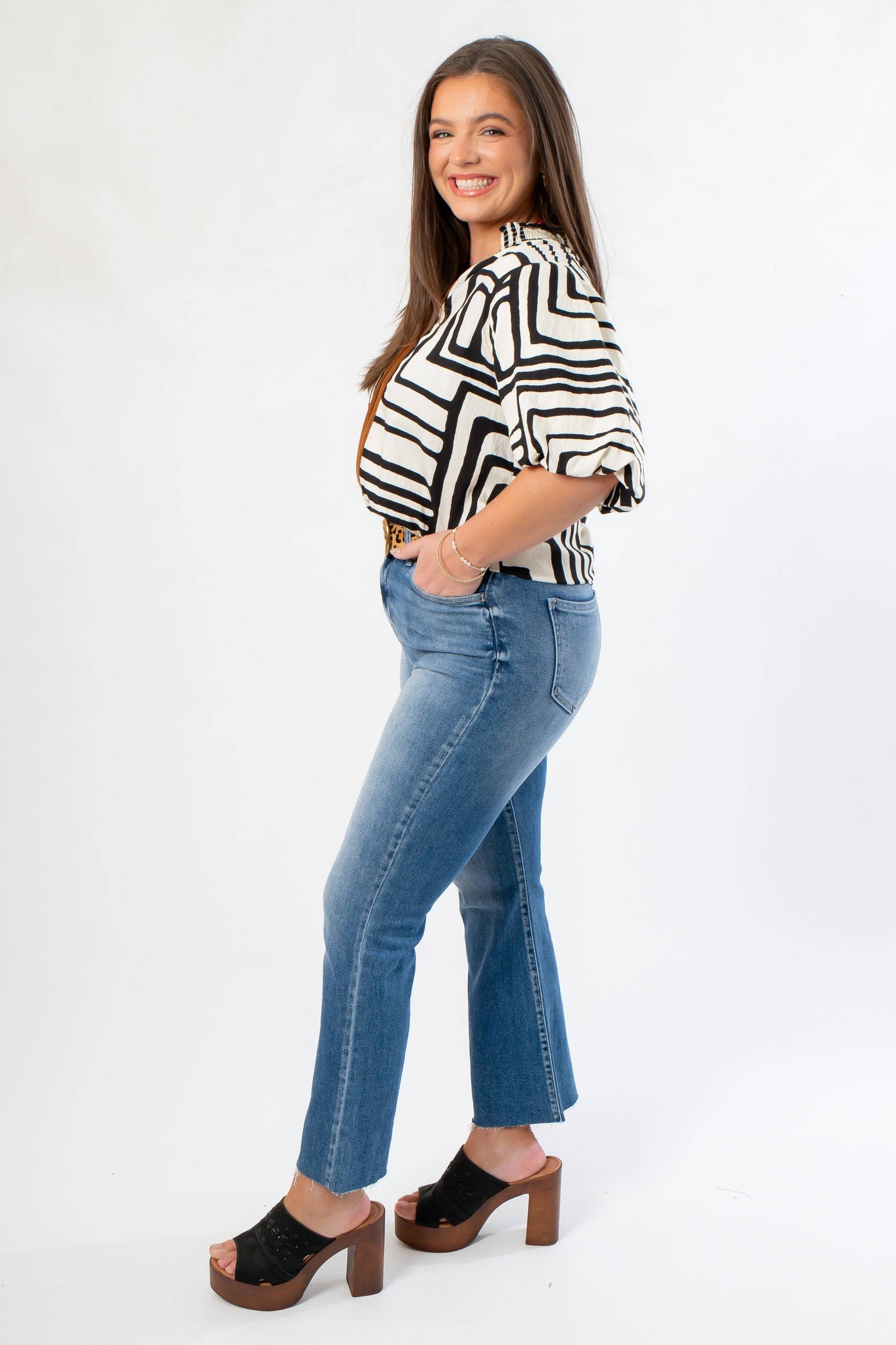 Side view of Medium Wash High Rise Crop Flare Jeans highlighting cropped flare cut and comfortable fit. Perfect for everyday wear.