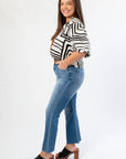 Side view of Medium Wash High Rise Crop Flare Jeans highlighting cropped flare cut and comfortable fit. Perfect for everyday wear.