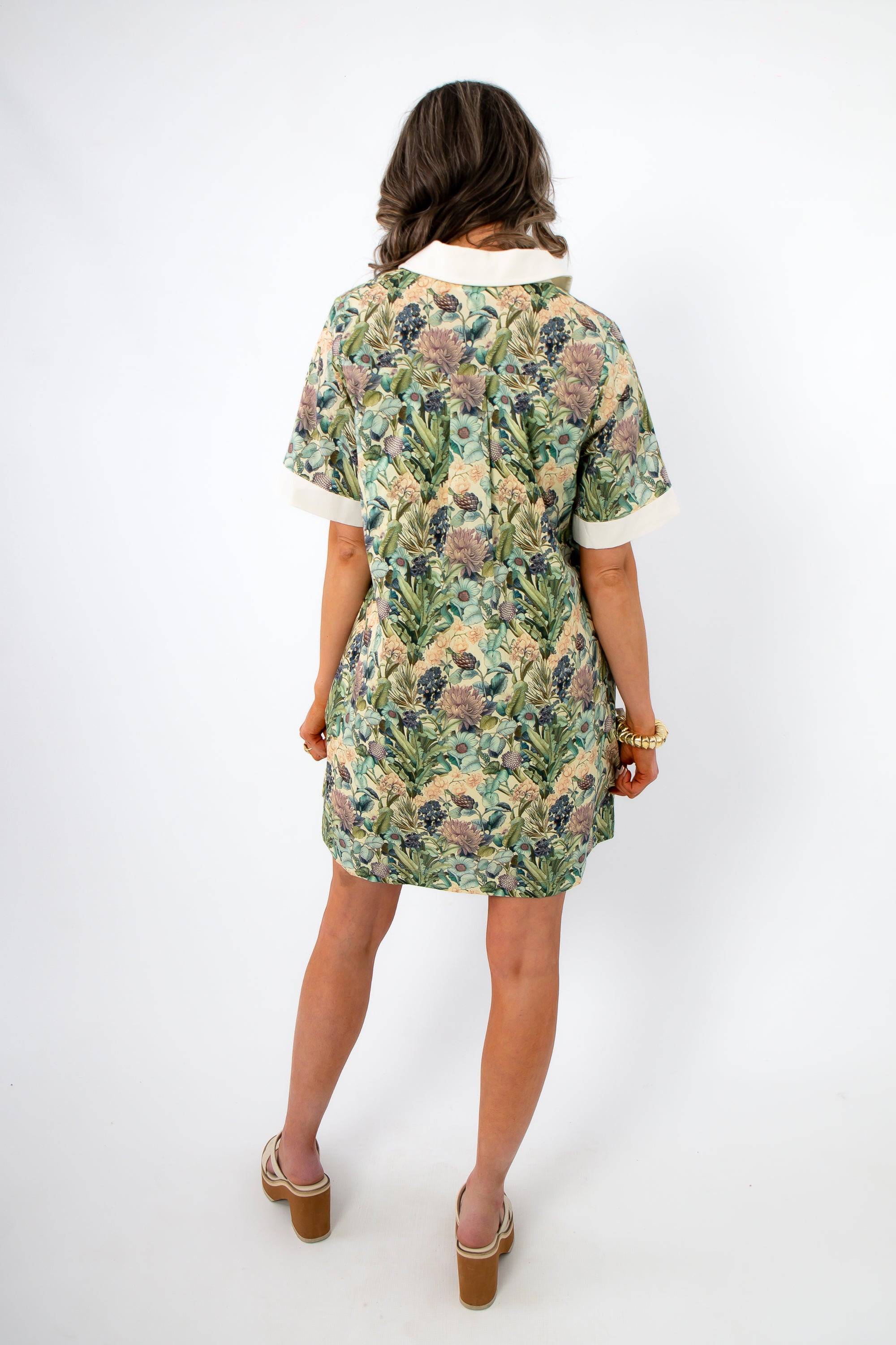 Back view of Martha’s Botanical Garden Collared Dress with pleated detail and short sleeves, highlighting its elegant floral spring pattern.