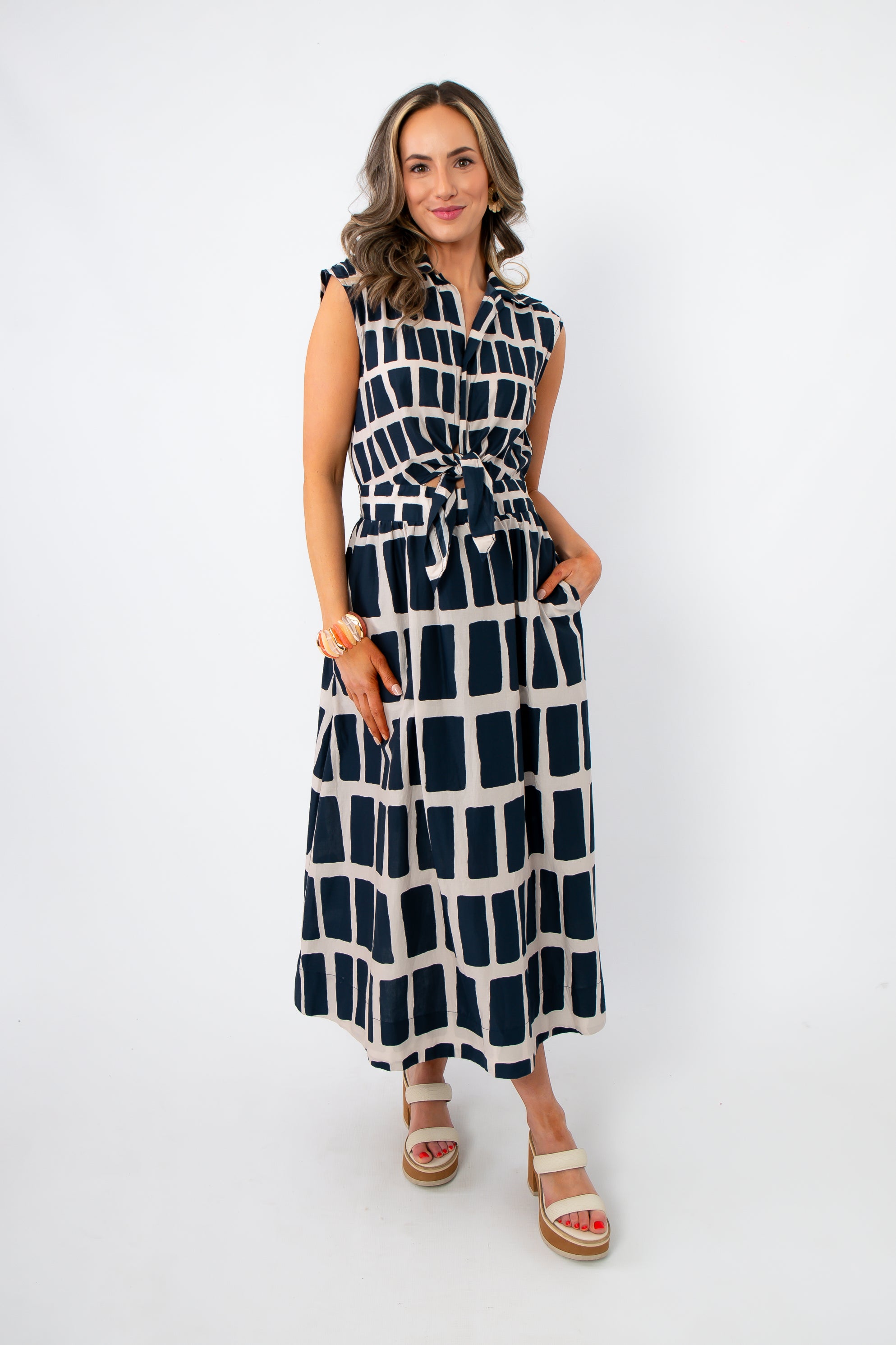 Newport Knot-Front Navy Midi Dress with keyhole tie waist and sleeveless design, styled for summer in a bold navy and white geometric print.