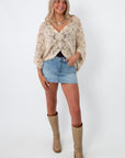 Model wearing beige crochet coverup cardigan, casual summer outfit, boho style