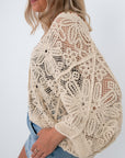 Back view of beige crochet coverup cardigan with floral design, beachwear