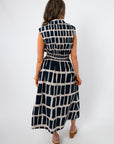 Back view of Newport Knot-Front Navy Midi Dress featuring elastic waistband and bold geometric pattern, ideal for versatile summer styling.