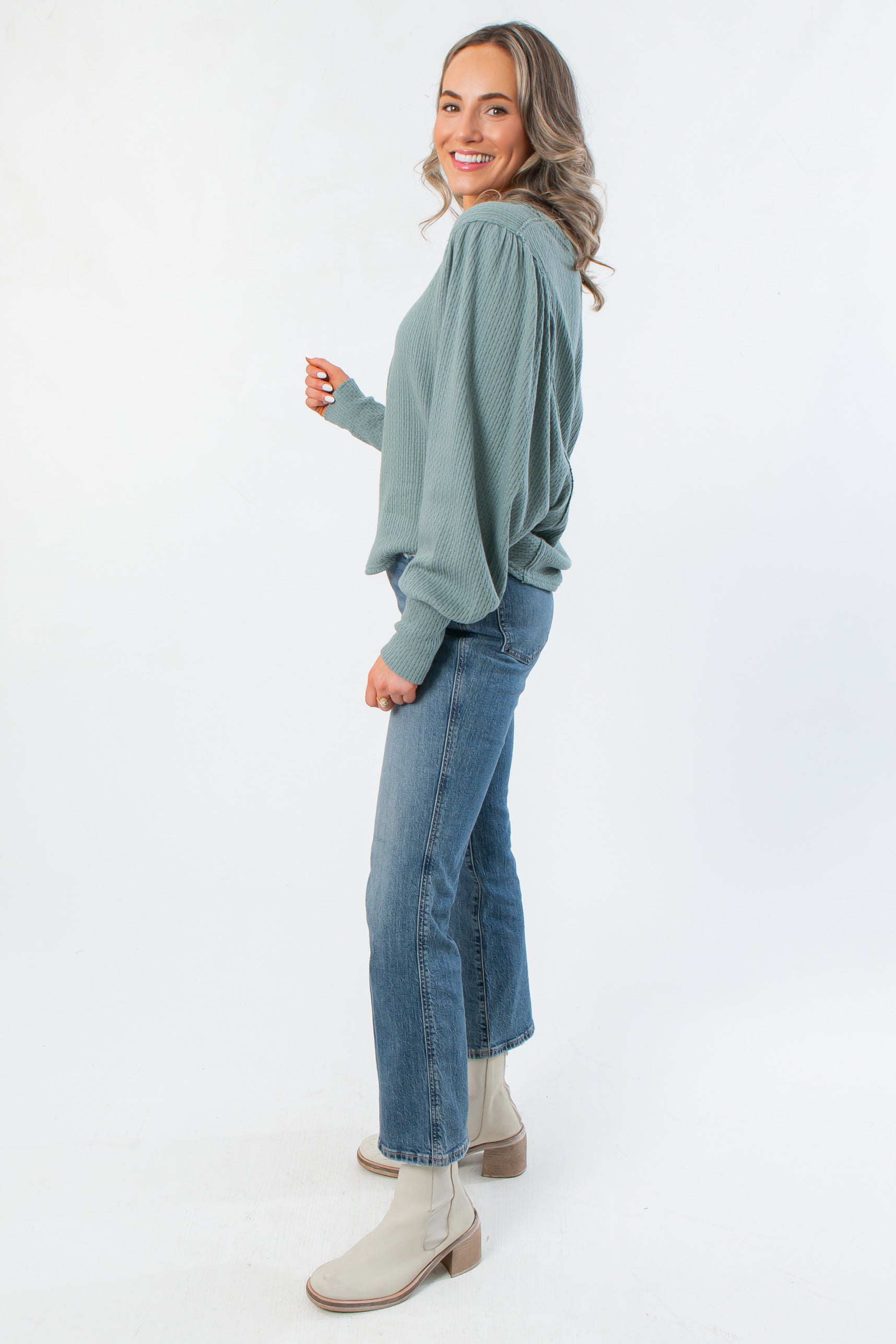 Side view of Free People Jade Ash Quinn Knit Thermal featuring dolman balloon sleeves and cozy thermal texture, ideal for layering in fall.