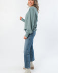 Side view of Free People Jade Ash Quinn Knit Thermal featuring dolman balloon sleeves and cozy thermal texture, ideal for layering in fall.
