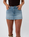 Side view of light wash denim mini skort, casual summer style