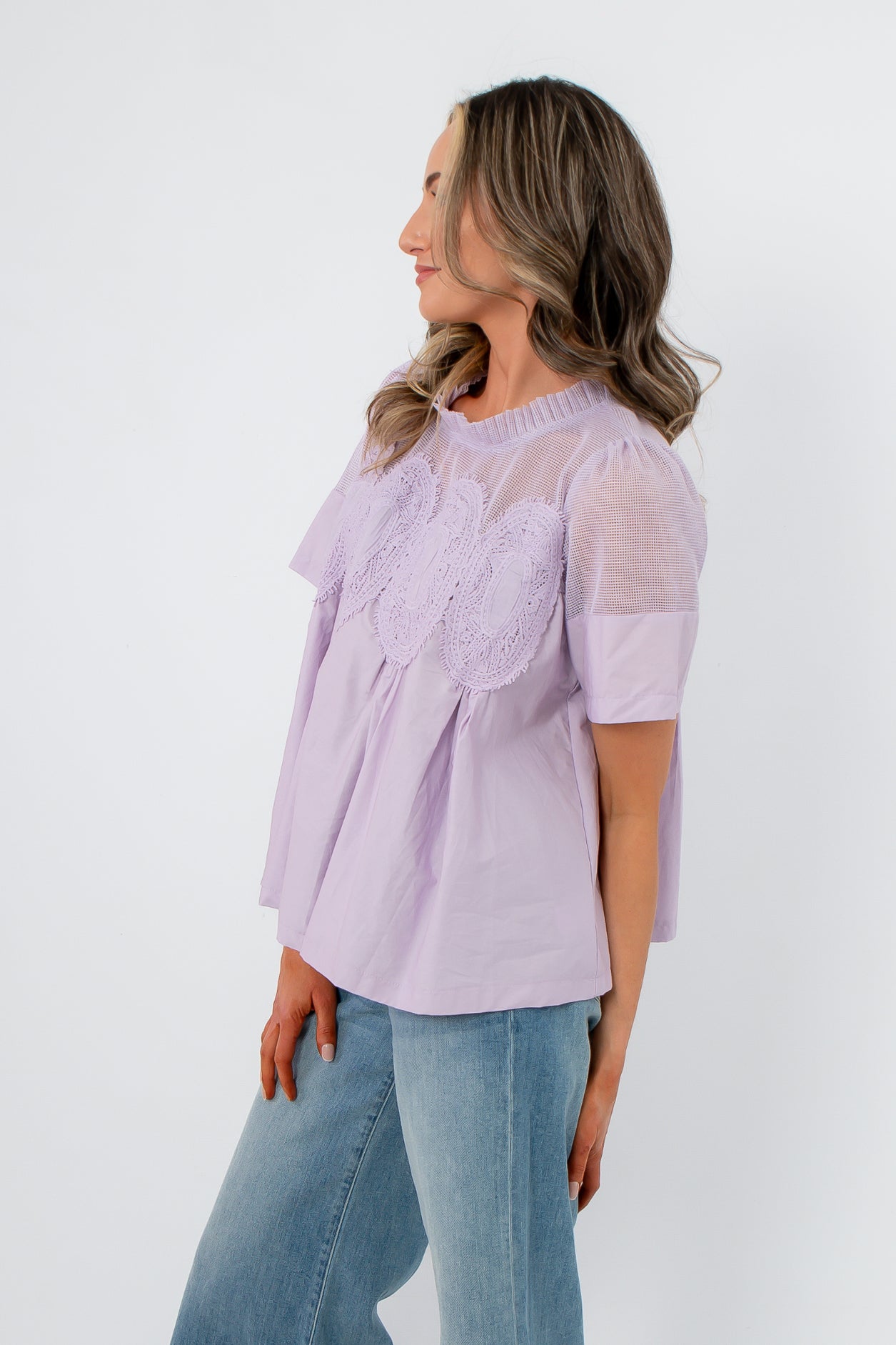 Side profile of Lacy Lavender Mesh Babydoll Blouse showing flowy silhouette and airy mesh fabric ideal for spring styling.