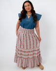 Model wearing floral midi skirt with smocked waist and side pockets