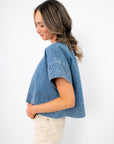 Indigo Daydream Chambray Denim Top | Side view of cropped denim shirt with short sleeves and textured trim, ideal for casual styling.