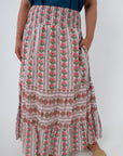 Close-up of floral printed midi skirt with pink flowers and striped pattern