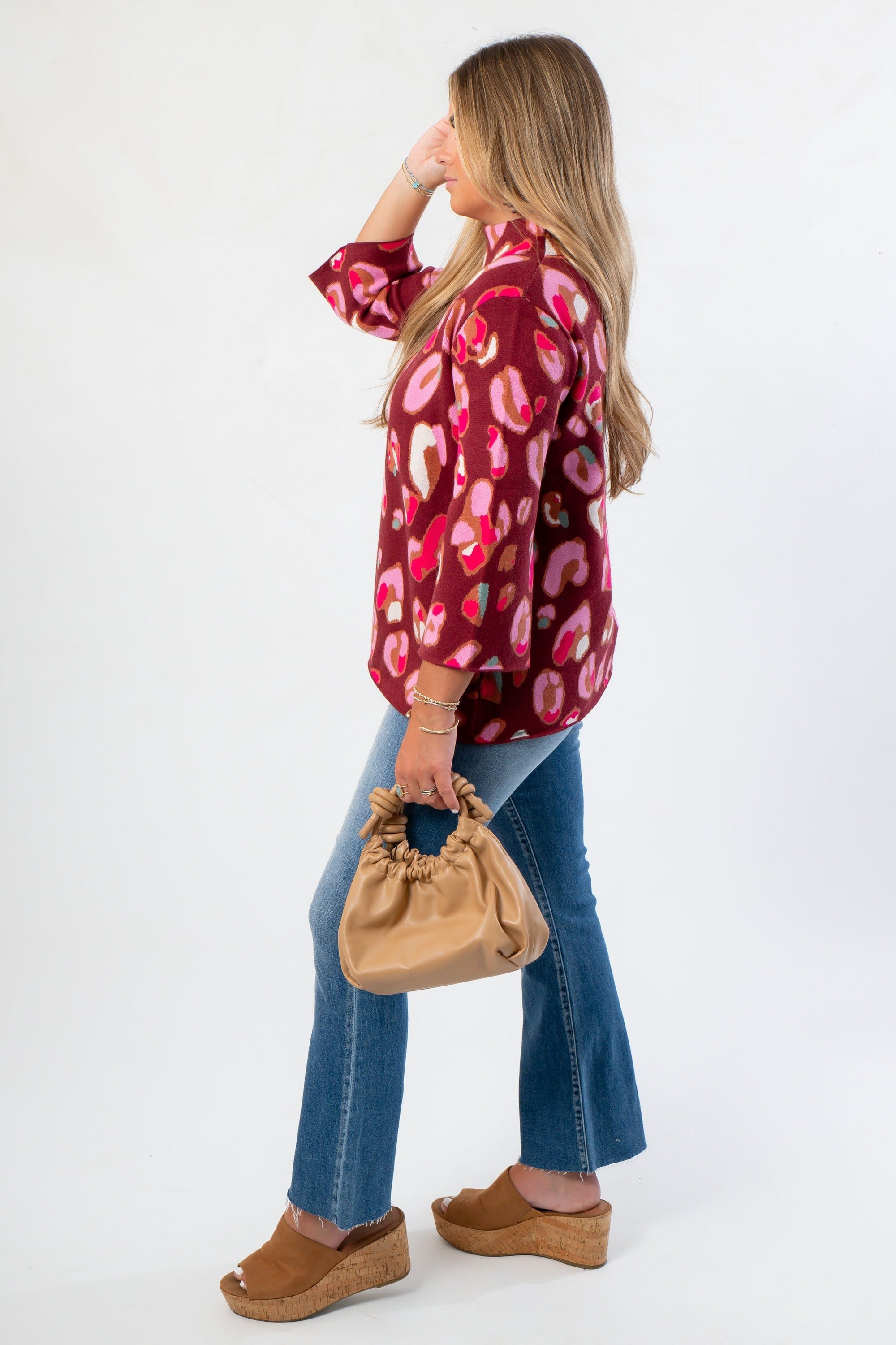 Side view of Animal Print Mock Neck Sweater - Fashionable Attire showcasing its loose silhouette and eye-catching print for everyday chic.