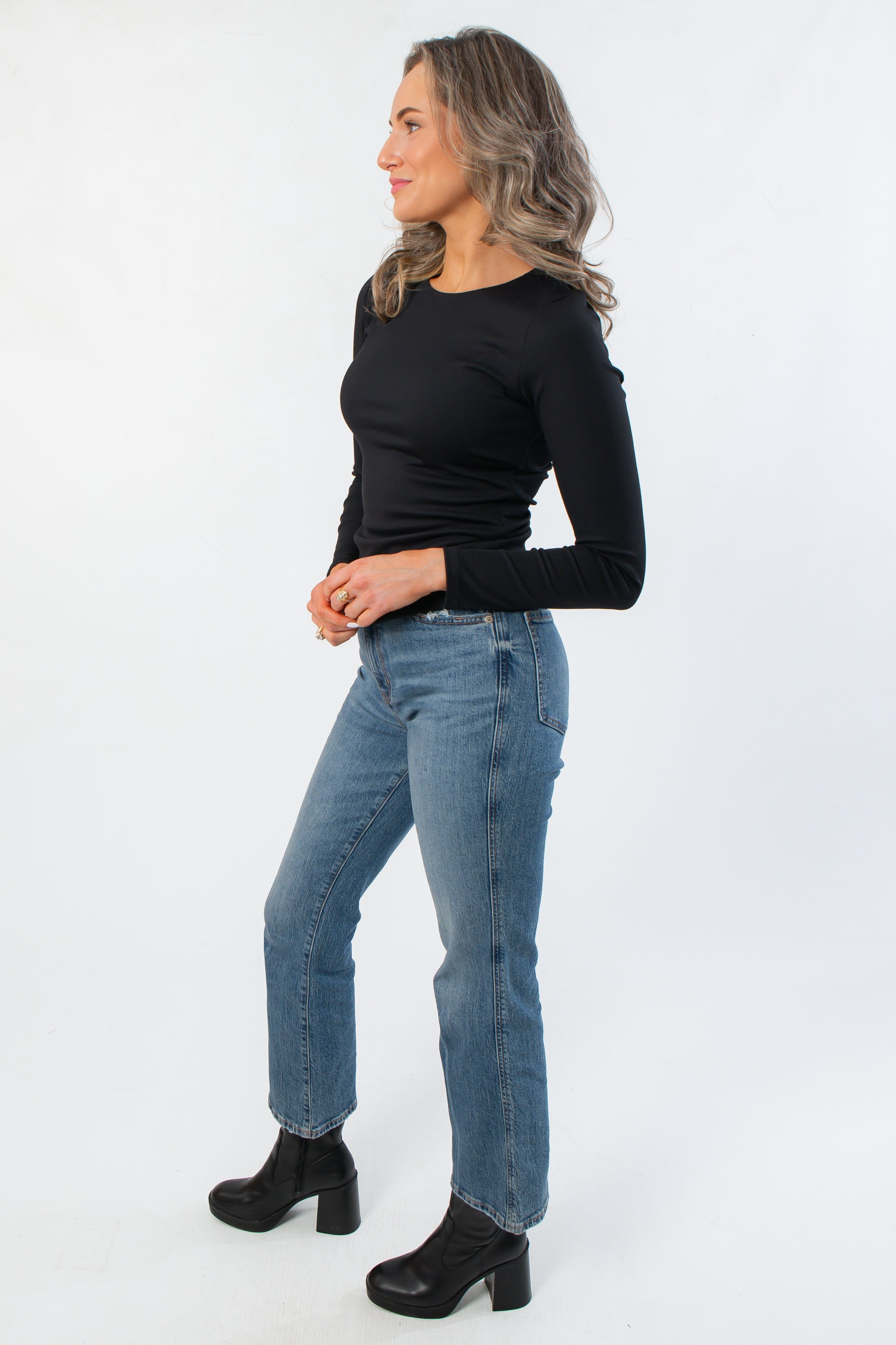 Side view of Roxi Jet Black Ribbed Knit Top showing its sleek, form-fitting silhouette, ideal for chic and versatile everyday wear.