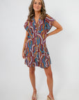 Front view of THML Tropadelic Short Sleeve Dress featuring colorful tropical print, short sleeves, and easy shift silhouette for casual wear.