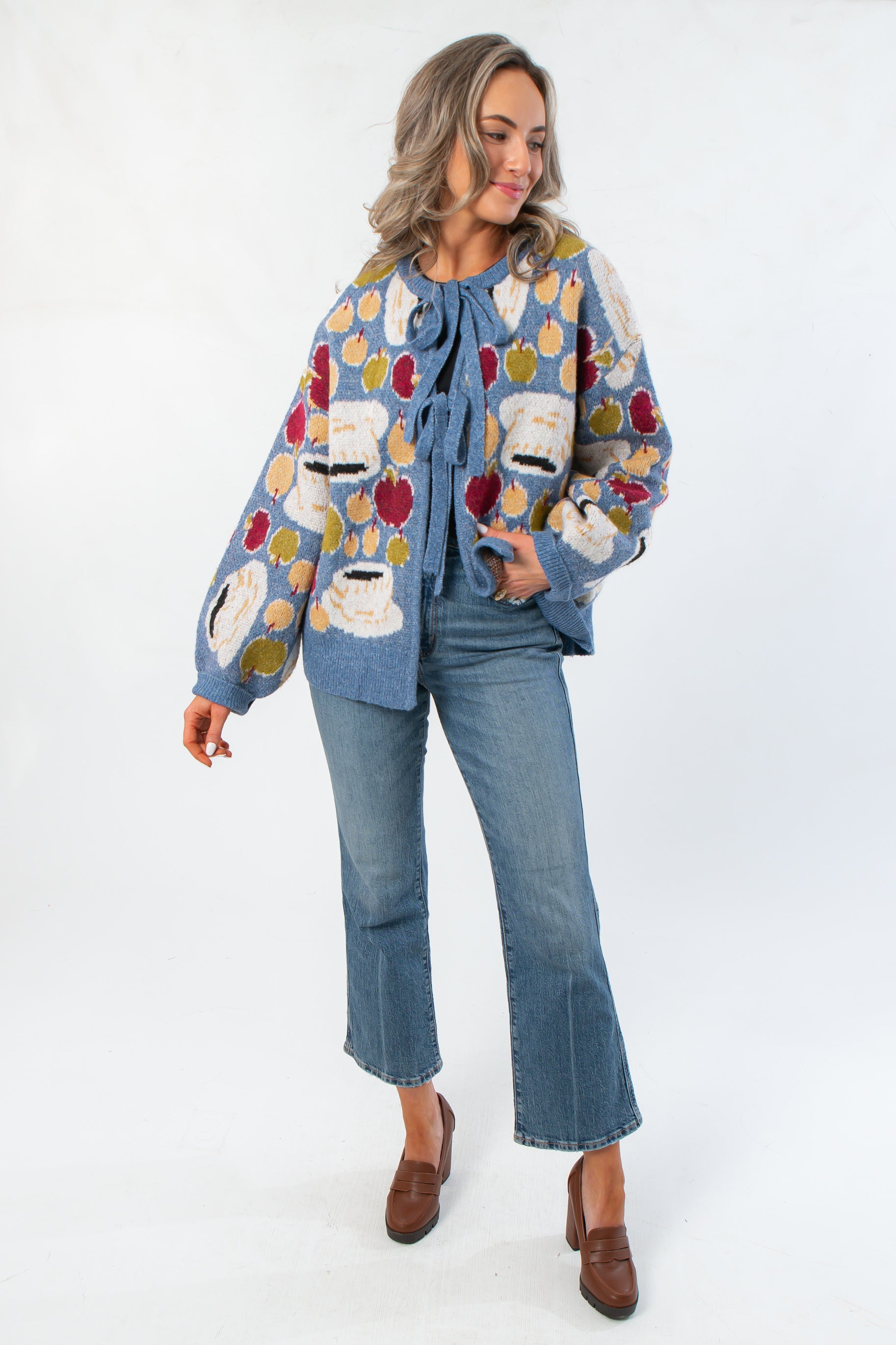 Front view of Apple A Day Blue Tie Front Cardigan featuring colorful apple pattern, long sleeves, and relaxed fit for stylish layering.