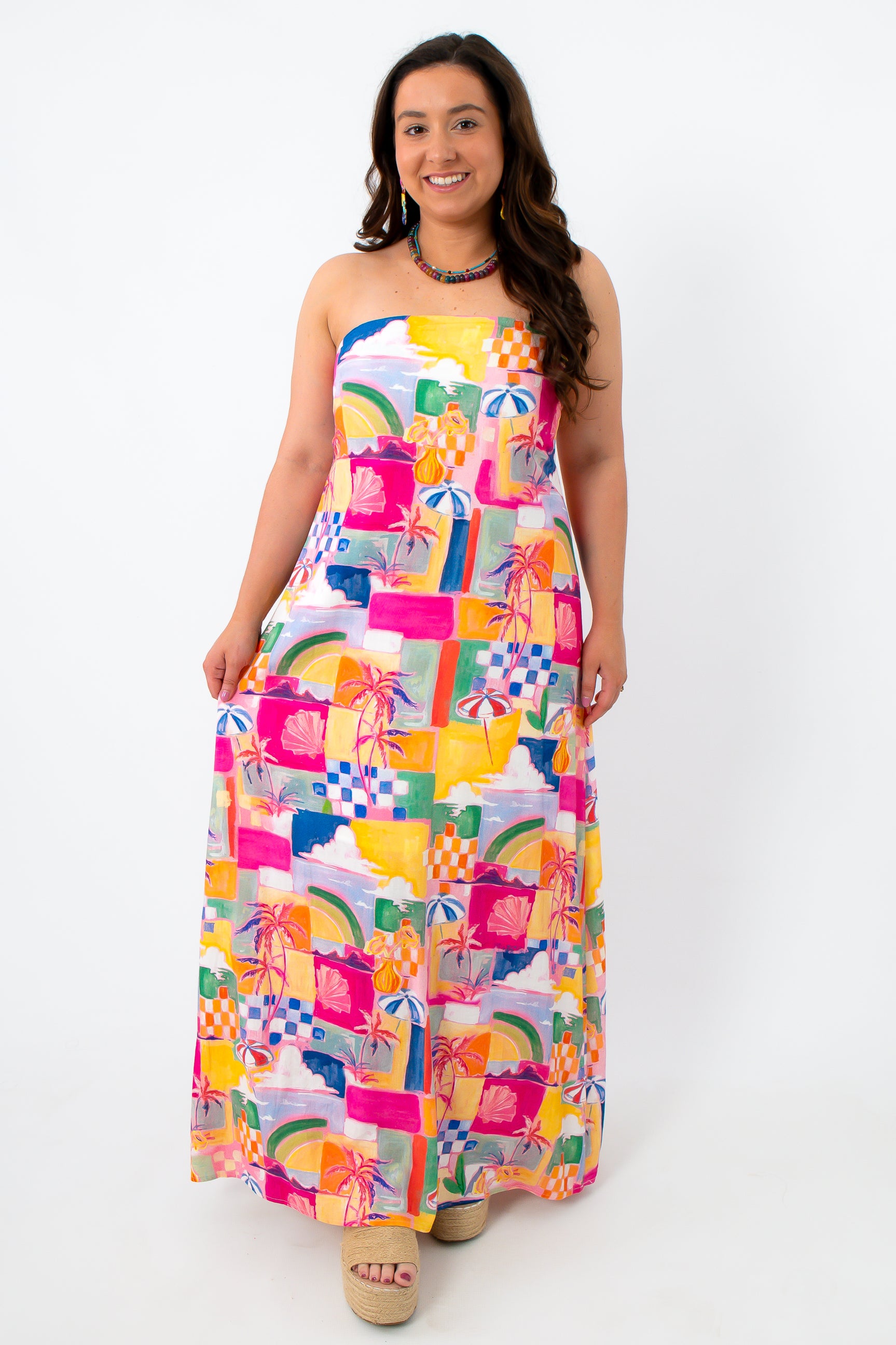 Colorful abstract summer dress with strapless design, palm trees, and beach scene print