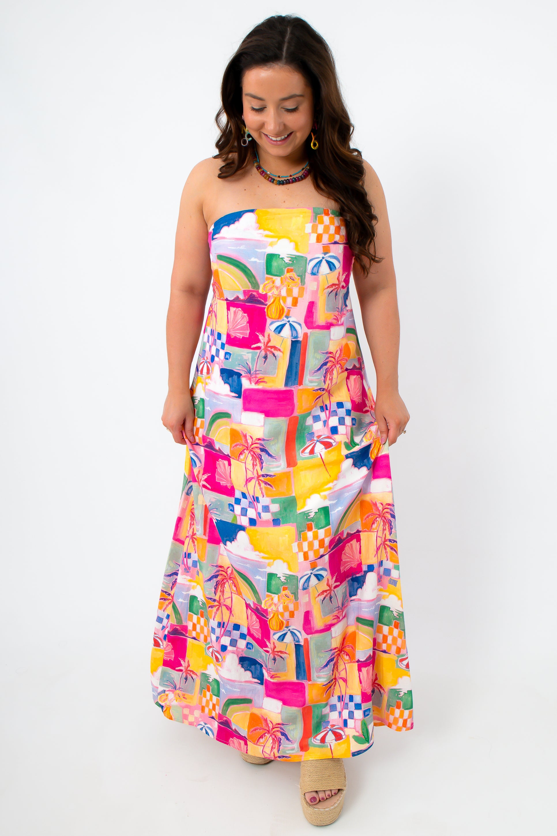 Front view of colorful abstract summer dress with strapless neckline and tropical print