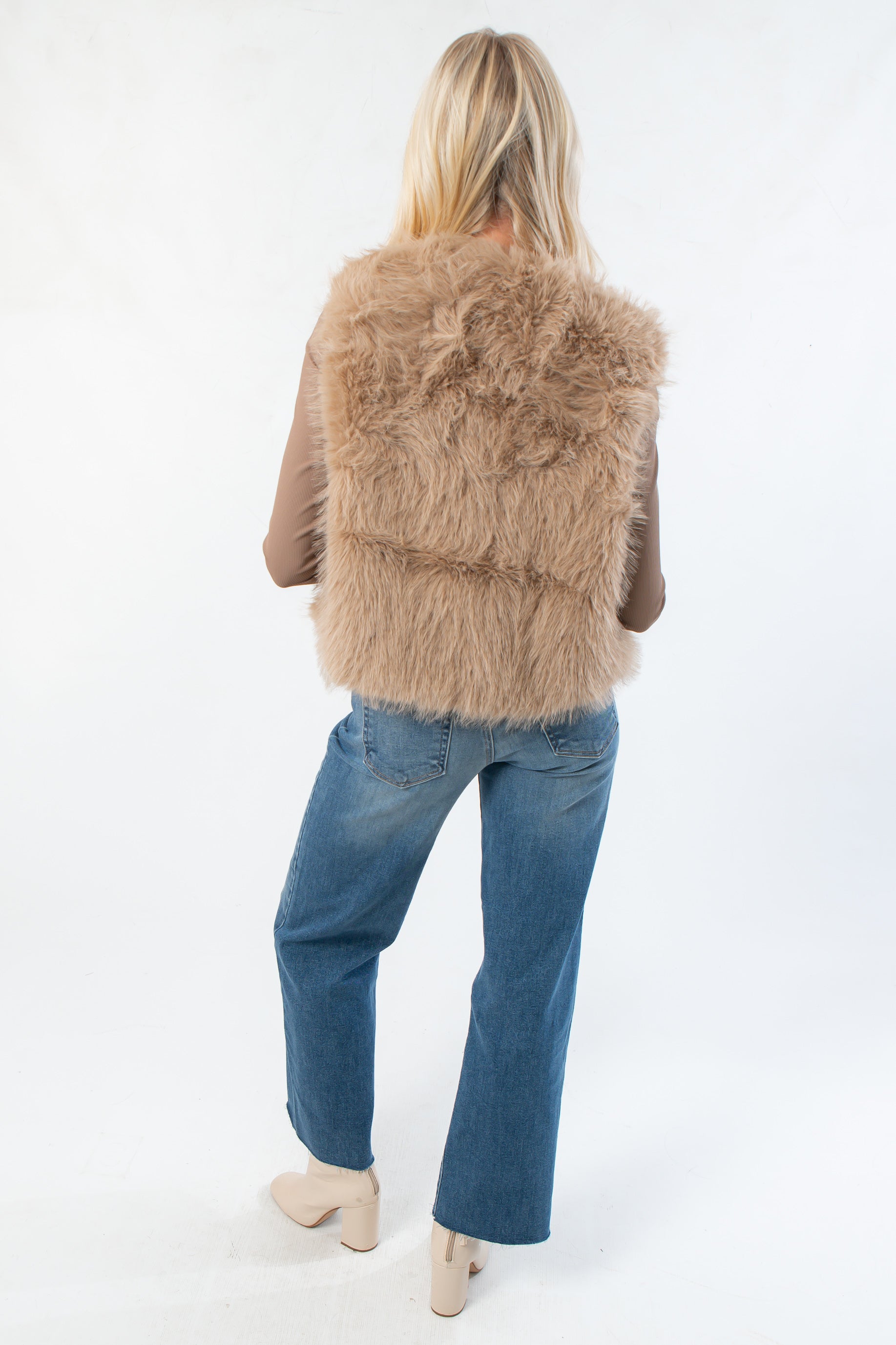 Back view of Fifth Avenue Taupe Faux Fur Vest highlighting its cozy faux fur design. Ideal boutique outerwear for layering in cool weather.