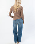 Back view of Roxi Ribbed Knit Top in clay taupe, paired with relaxed denim, highlighting its versatile boutique knitwear style.