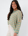 Side view of Coastal Spring Stripe Sweater in mocha and aqua stripes, showcasing its lightweight knit and loose silhouette for coastal style.