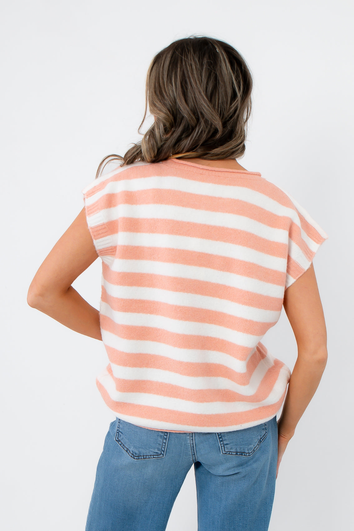Back view of Rosie Peach Stripe Sleeveless Sweater Vest with wide horizontal stripes and cap sleeves, ideal for layering over tees or blouses.