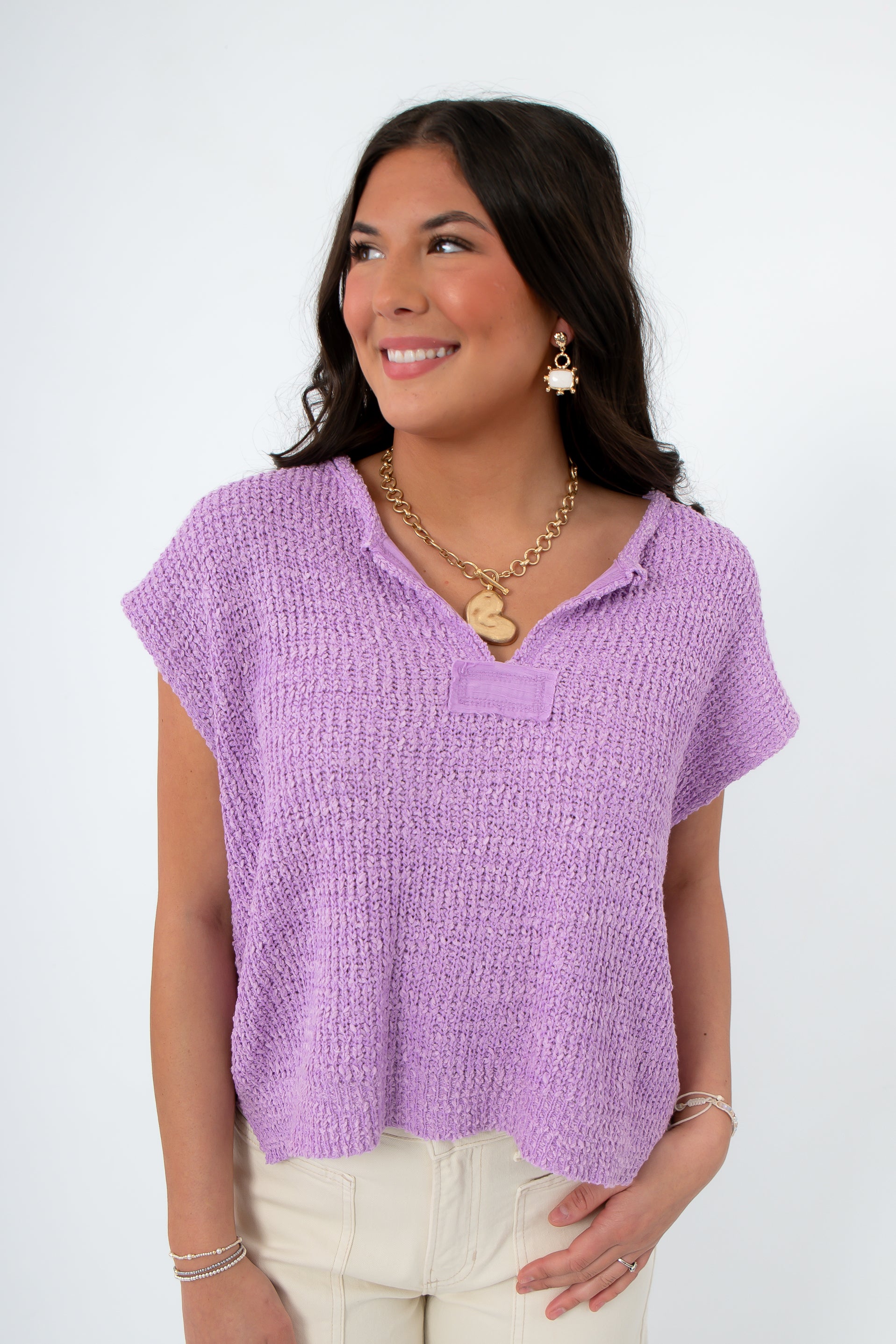 Wisteria Willow Lilac Crop Sweater with short sleeves and textured knit, styled with layered gold necklaces for a spring-ready casual look.
