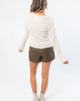 Back view of Free People Through the Woods Tee - A Frame Combo We The Free Knit Top with subtle ruffle hem and soft ribbed fabric.