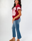 Side view of Burgundy Bow Cable Knit Top showing textured knit design and feminine pink bow, ideal for pre-fall and holiday styling.