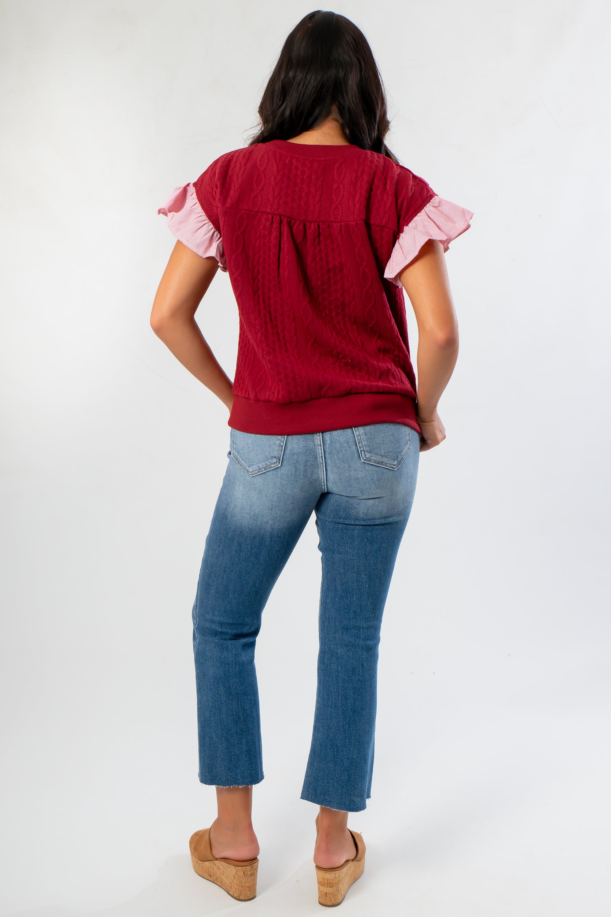 Back view of Red Burgundy Knit Top with cable knit pattern and ruffle sleeve detail, offering a cozy and stylish wardrobe upgrade.