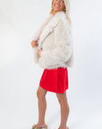 Side view of Winter Wonderland Ivory Faux Fur Jacket in a cozy, plush texture. Stylish women's coat for chic winter outfits and special occasions.